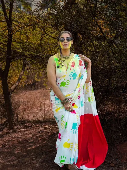 A stylish portrait from a Holi-themed fashion shoot. The colorful handprints on the saree create a unique and festive look, blending tradition with modern fashion sensibilities.