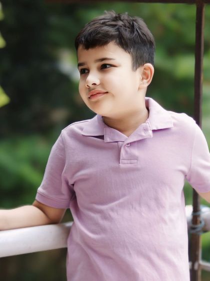 A thoughtful, candid moment of my son on the balcony. I look for these quiet, in-between moments that show a child's contemplative side.