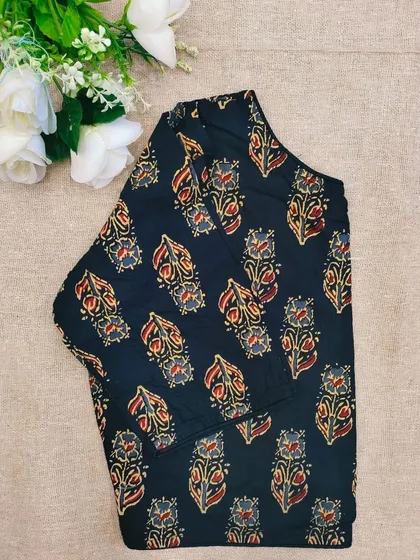 A black cotton boatneck blouse with a classic floral bootidar print.