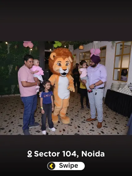 Families posing with the lion mascot. It's a popular photo opportunity for guests of all ages.