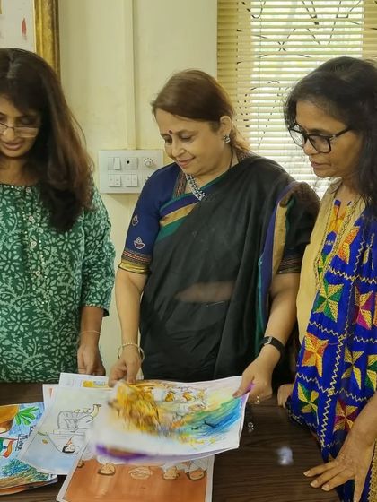 Here we are, carefully looking at one of the beautiful paintings. Judging is not just about picking a winner, but about appreciating the effort and imagination of every single child.