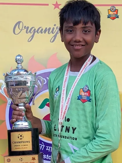 The smile of a winner. Our goalkeeper with the 3rd place trophy, a reward for his excellent saves.
