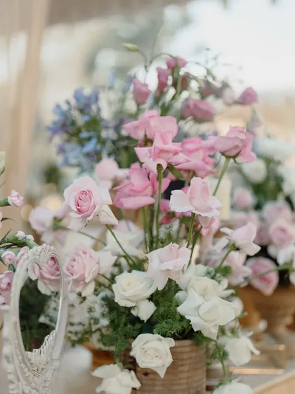 A soft and romantic floral arrangement with pink and white roses.