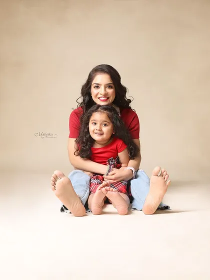 A sweet and simple portrait showing the size difference between mom's and daughter's feet. It's the little details that make memories.