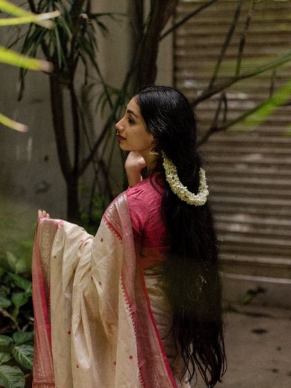 A side profile shot with jasmine flowers in my hair, showcasing a traditional South Indian hairstyle.