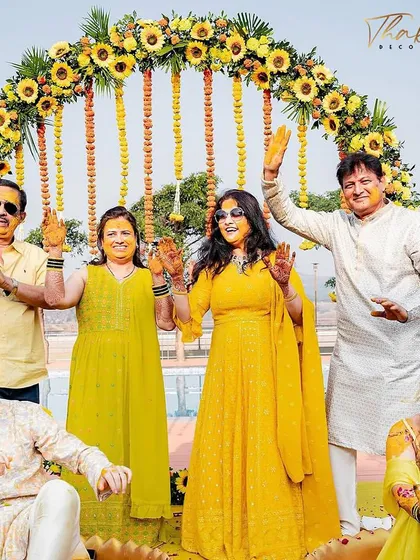 A family portrait from a Haldi ceremony, set against a beautiful circular arch of sunflowers. It's moments like these that I aim to create the perfect backdrop for.