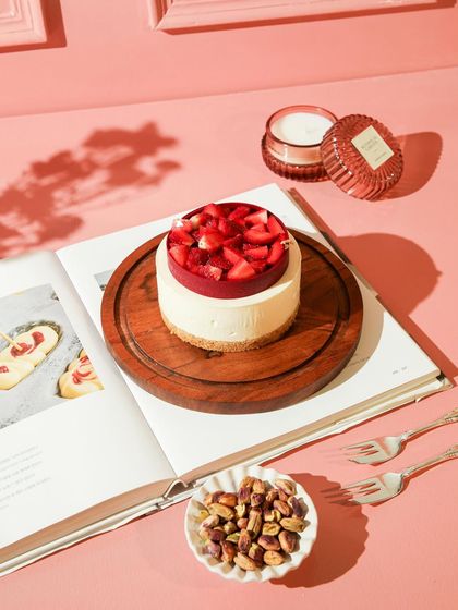 A beautifully styled shot of our Strawberry Cheesecake, perfect for a quiet moment of indulgence.