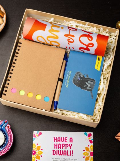 This hamper is a mix of practical and fun items, including a notebook with pen, a pair of earphones, and a branded bottle, making it a useful gift for employees.