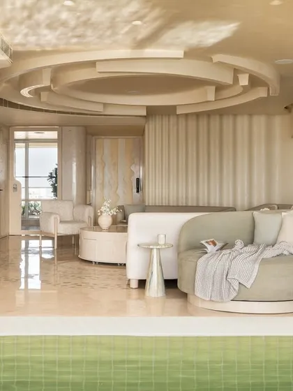 In our Soft Serve apartment, we explored the Japanese concept of 'Seijaku' or tranquil stillness. The living space is a sequence of intersecting circles and curves, creating a calm, hypnotic visual in a palette of soft, monolithic tones.