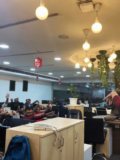 A moment of shared fun and relaxation during an office yoga session. Creating a positive and light-hearted atmosphere is key to making wellness an anticipated part of the company culture.