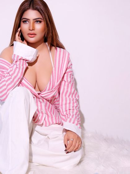 A clean and simple studio portrait with a casual, unbuttoned shirt. The soft lighting and relaxed expression create an approachable and friendly feel.