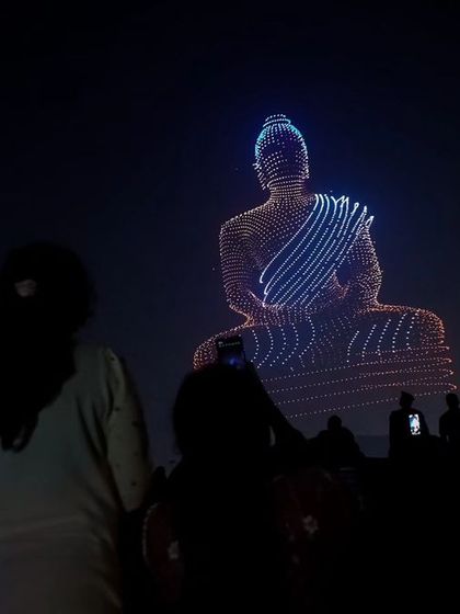 A stunning formation of a meditating Buddha, created during our record-breaking show in Amaravati. The crowd watches in reverence, capturing the serene moment.