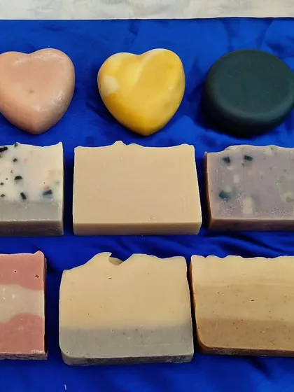 A vibrant lineup of my different soap creations, including heart-shaped, round, and rectangular bars.