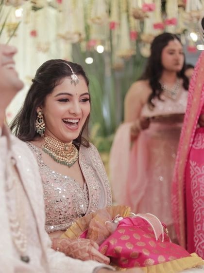 All smiles and sparkles for this bride's engagement. This candid shot captures her pure joy during the ceremony, with her makeup looking fresh and radiant.