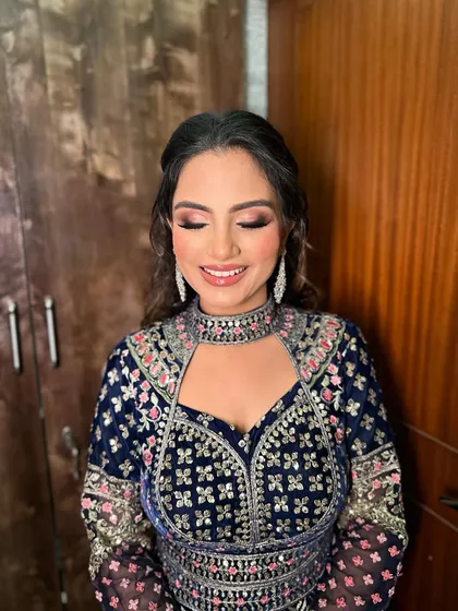 Heer's eyes closed, showcasing the dramatic yet soft smokey eye created for her evening look.