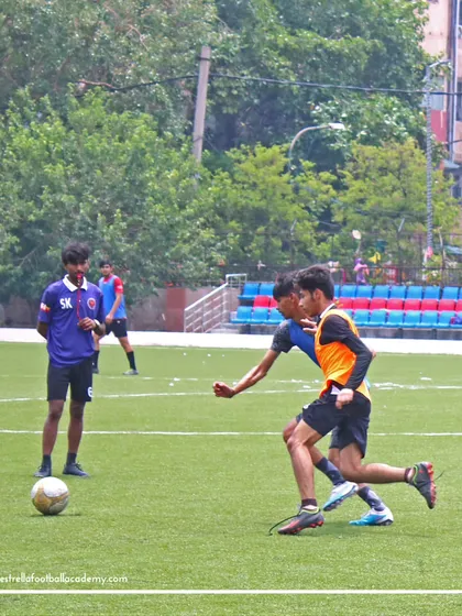 An intense one on one battle for the ball during the Spain international camp trials, showcasing the competitive spirit I look for in players.