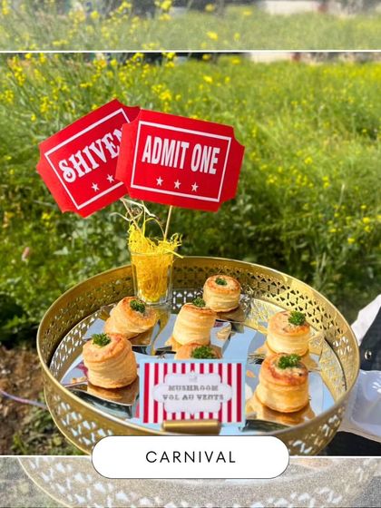Mushroom vol-au-vents served on a golden tray with 'Admit One' ticket decor. This appetizer adds a touch of elegance to the fun and casual carnival atmosphere.
