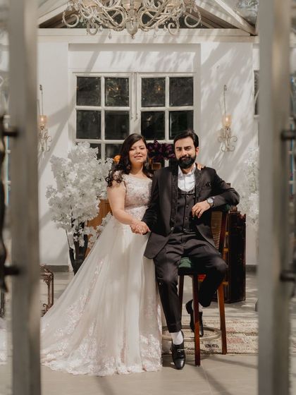 A beautifully framed shot of the couple through a doorway, giving a sense of intimacy and a peek into their world.