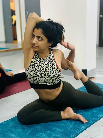 This student shows incredible openness in her shoulders and hips as she gracefully holds the Mermaid Pose.