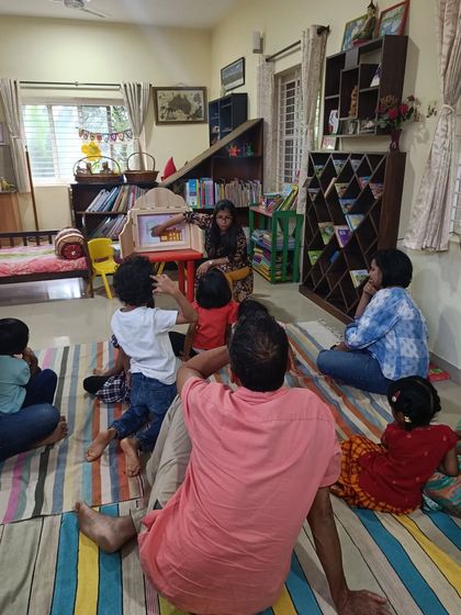 A wider view of the Kamishibai session, showing how this unique prop captures the attention of the entire room.