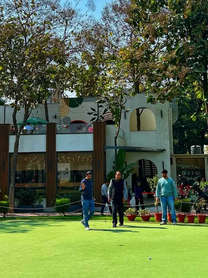 A group of friends enjoys a casual putting contest on the green in front of our clubhouse.