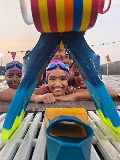 A creative and fun shot of my swimmers peeking through a pair of fins. We are always finding new ways to enjoy our time at the pool together.