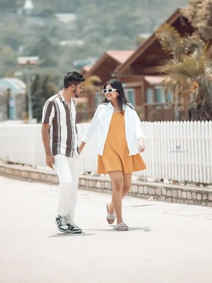A casual walking shot of the couple in a resort-like setting near the river. This shows the variety of locations we can use, including nearby cabins and paths.