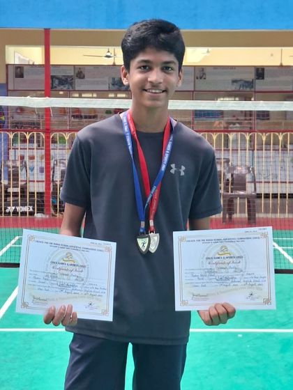 This student showcases his two medals and certificates, a reward for his excellent performance. We train our players to be competitive in both singles and doubles events.