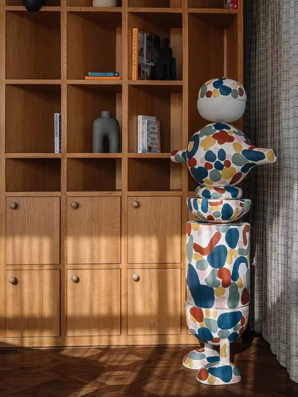 This custom 'MuseTRIBE' floor lamp is a scaled-up version of the wooden toys we designed with Channapatna artisans. We collaborated with an artist to hand-paint the lamp, turning it into a vibrant, oversized sculpture that brings life to the library.