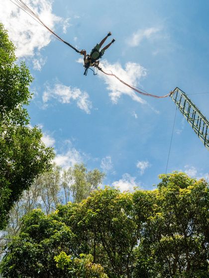 A participant is launched high into the sky on the Rocket Ejector, a true test for any thrill-seeker.