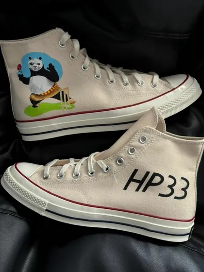 A detailed view of the Hardik Pandya custom Converse, featuring a cartoon panda and his jersey number "HP33."
