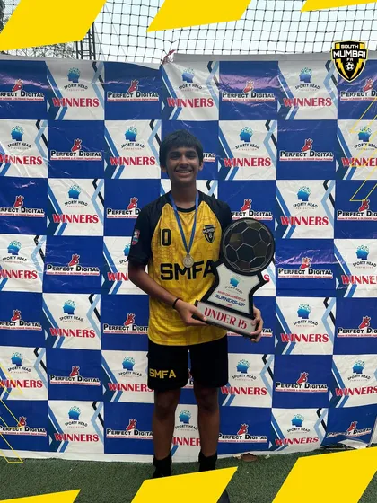 Arham Ansari, awarded Best Player for the U15 category, with the team's Runners-Up trophy. We celebrate both team and individual excellence.