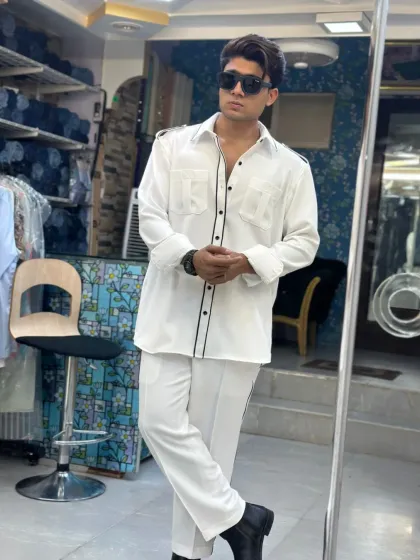 Style that’s relaxed but still makes a statement. This all-white co-ord set with black piping details is custom-made for comfort without compromising on class.