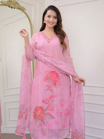 A pretty light pink organza kurta with a delicate floral print. The fabric is so light and airy, making it perfect for a summer event.