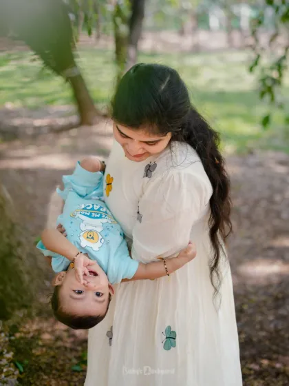 A playful, upside down view of the world for this happy baby, held securely in his mother's arms. We love capturing these spontaneous moments of fun during our outdoor shoots.