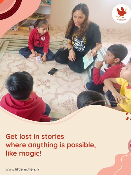 A teacher sits on the floor with a small group of captivated children, reading a story aloud. These magical storytime sessions are where we spark wonder and build essential language skills.
