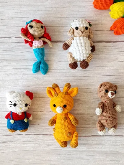 For the little ones, I create a range of cute crochet creatures. This collection includes a mermaid, sheep, Hello Kitty, giraffe, and teddy bear, perfect as birthday gifts or party favors for a kid's celebration.