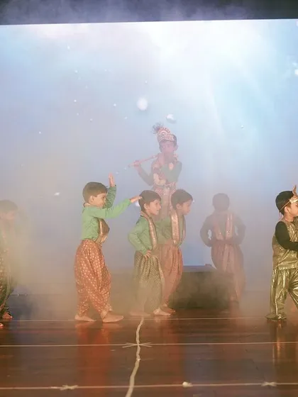 I use professional stage effects like smoke machines and dynamic LED backdrops to create a theatrical experience for annual day performances. This moment from a Maple Bear event highlights the production quality I bring to school stage shows.
