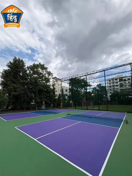 Another view of our vibrant purple and blue pickleball courts. We believe in providing high-quality, aesthetically pleasing environments for our players to train and compete in.
