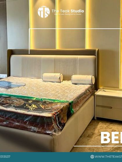 This modern beige bed features a clean-lined headboard with vertical channel detailing. The warm backlighting on the wall panel enhances the room's ambiance.