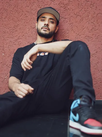 A relaxed portrait of actor Adnan Khan. This shot showcases my work with male actors, creating a cool and approachable look with a simple urban background.