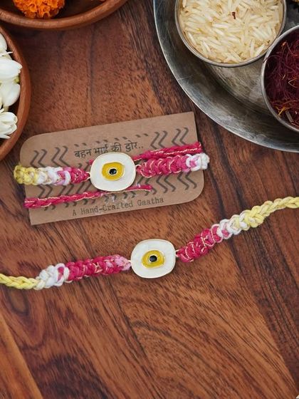 The yellow Evil Eye Rakhi set, a perfect gift for your sibling.