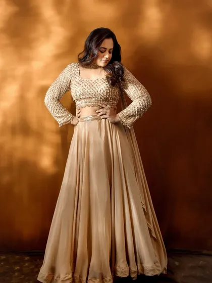 A confident pose from Spruha Varad, showcasing the full effect of her Filmfare red carpet attire.