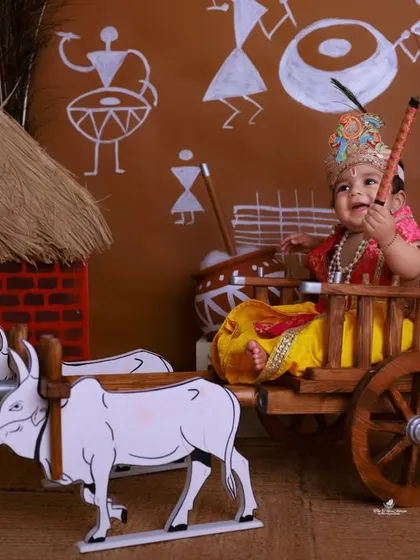 A happy little Kanha enjoying his ride. The dynamic angle and the child's joyful expression make this a lively and engaging photograph from our Janmashtami series.