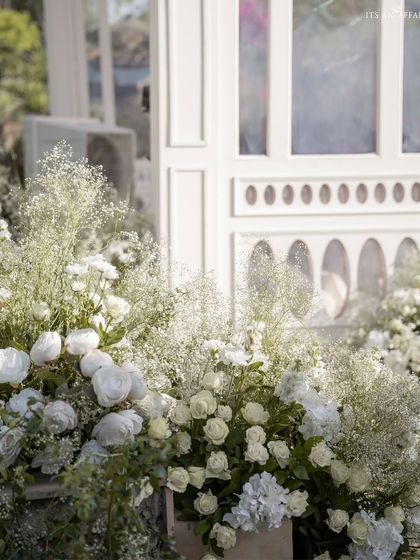 Clouds of white baby's breath and roses soften the architectural lines of the decor, adding to the heavenly feel of the lakeside ceremony.