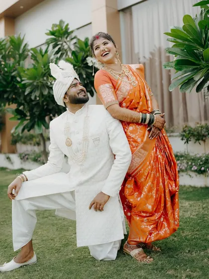 Playful and full of laughter. This candid portrait captures the fun side of a couple's relationship on their wedding day, with the bride leaning happily on her groom.