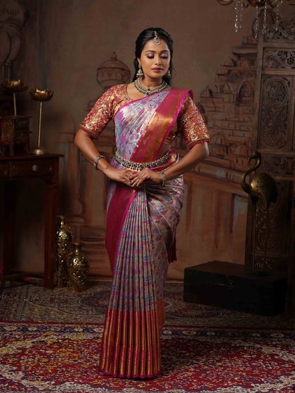 The front view showcases the symmetry and neatness of the 'Fluffy Pleats'. This draping style is especially flattering for silk sarees, enhancing their natural sheen and richness.