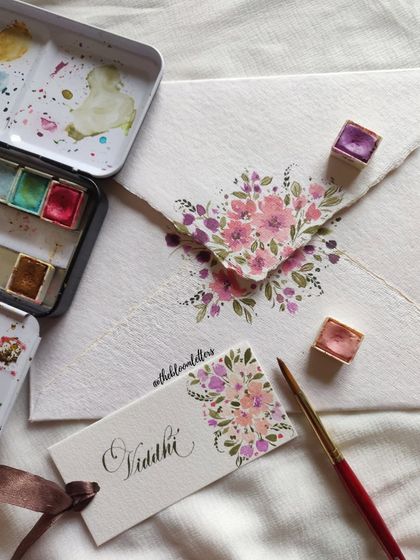 A detailed shot of a hand-painted name tag and matching envelope, created as a token of gratitude for one of my mentors.