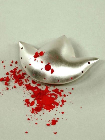 This stunning silver bird-shaped piece, accented with red powder, is an example of the creative possibilities that open up once you master the basics of silversmithing.