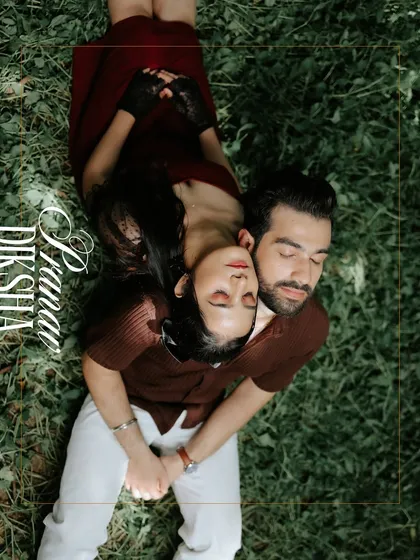 An artistic overhead shot of the couple lying on the grass. This creative perspective captures a moment of peaceful togetherness and connection.